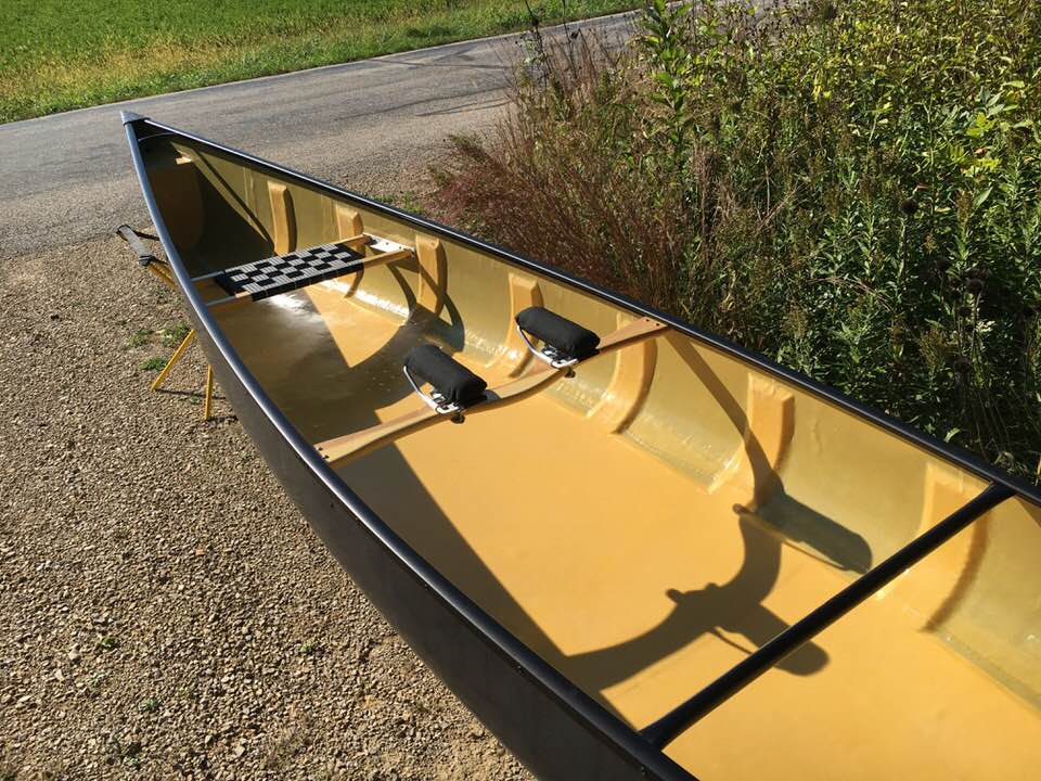Finished composite canoe by Randy Pfeifer laying right side up in a driveway