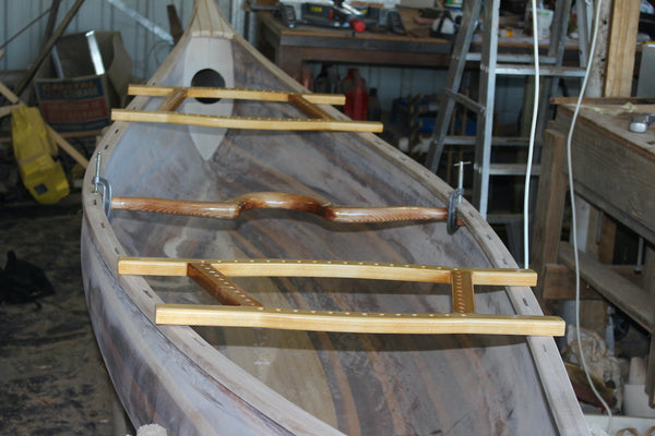 Champlain canoe with yoke and trim laid out in preparation for installation