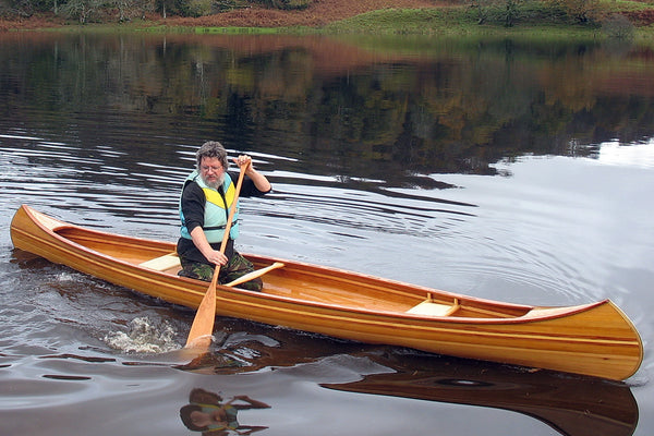 Jon Belton paddling a Redbird wooden canoe on Loch Awe