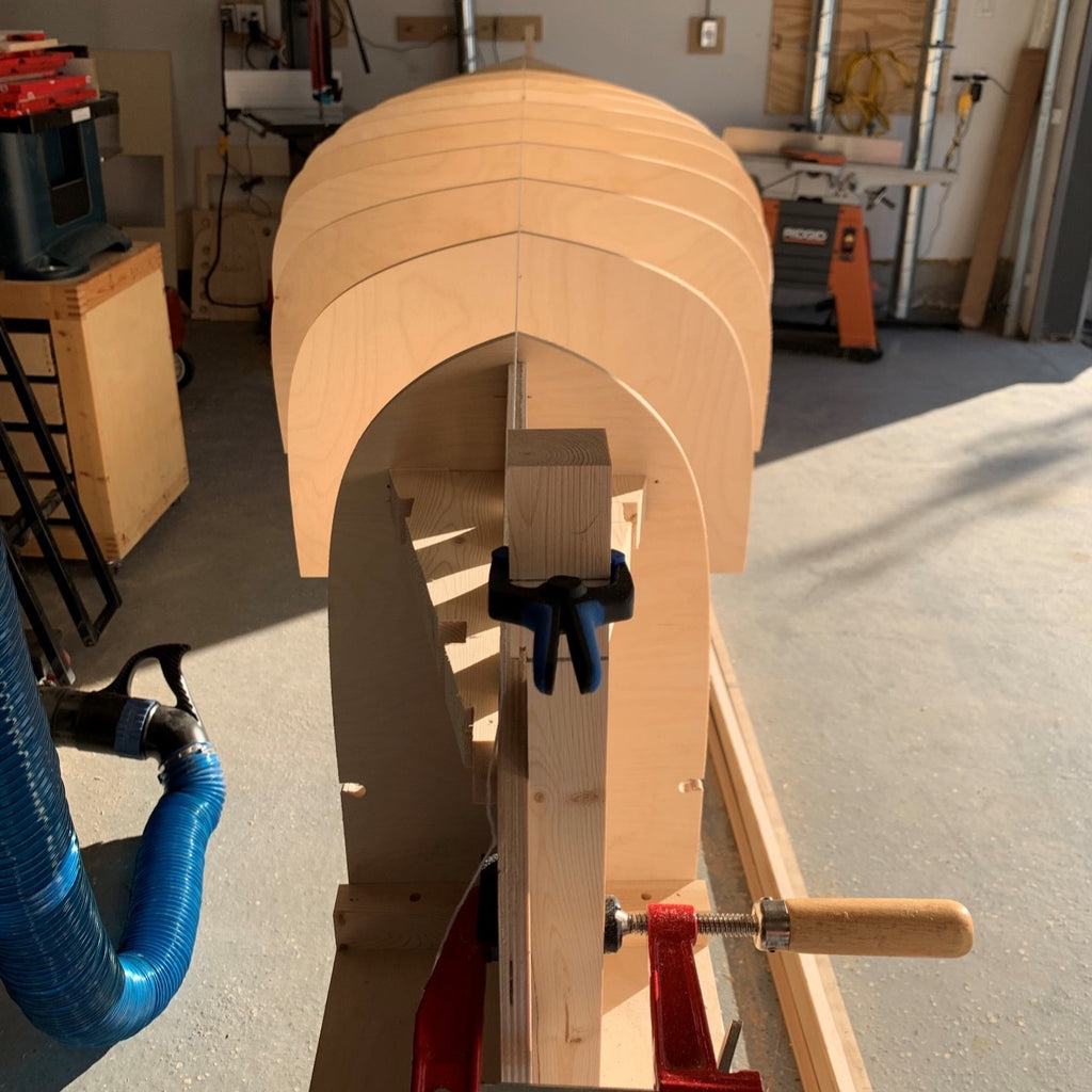 Light falls on a canoe strongback with station molds installed