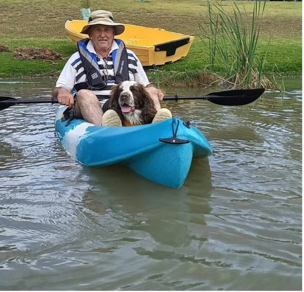 Man in a kayak with a dog