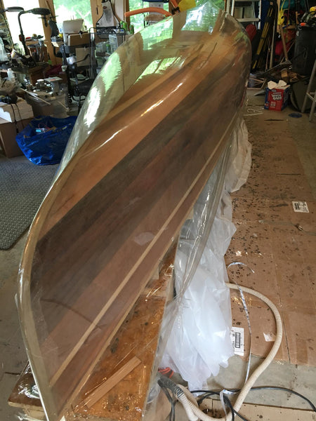 Freedom 17 hull covered in plastic shrink wrap prior to use as a male mold