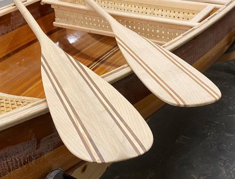 Two canoe paddles balanced across the gunwales