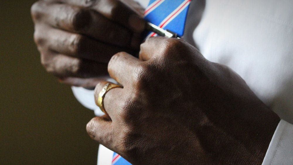 closeup of man in tie wearing wedding ring
