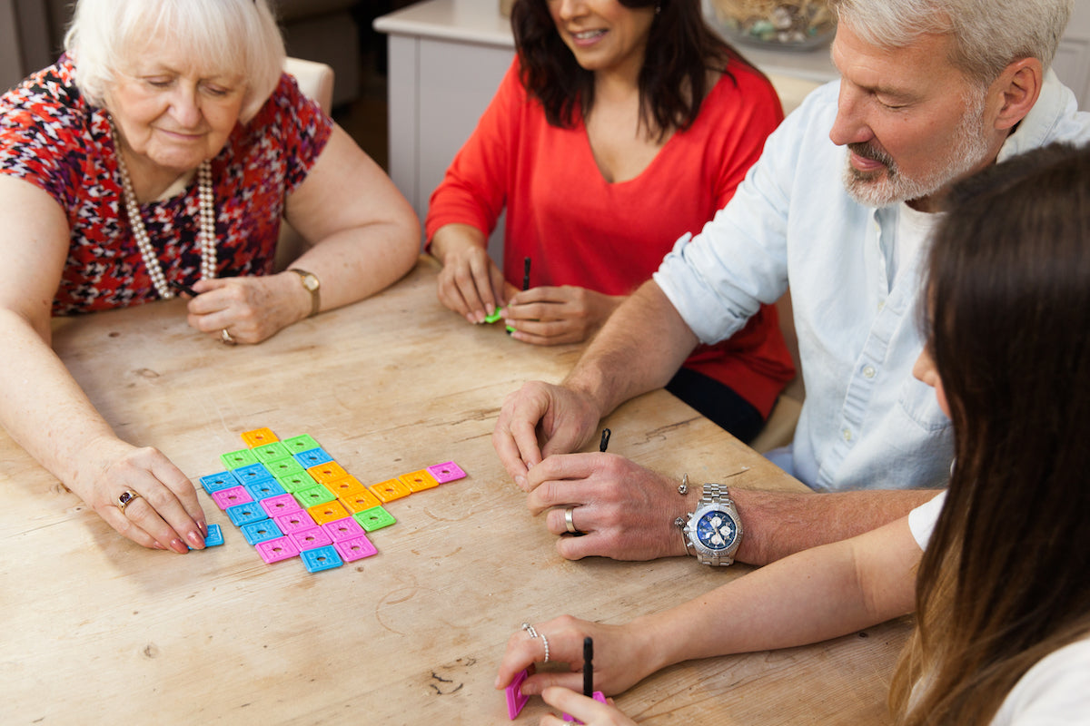 Group of people playing a game of OK Play.