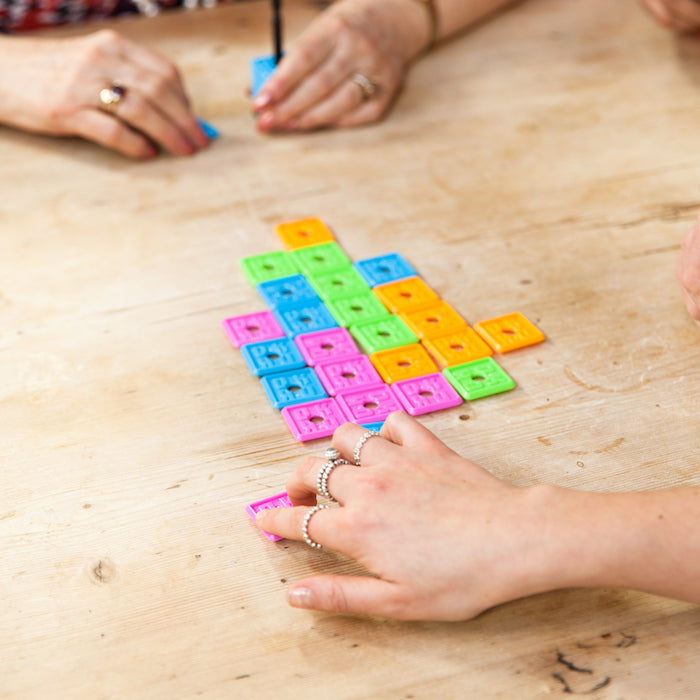 People playing OK Play, with tiles assembled.