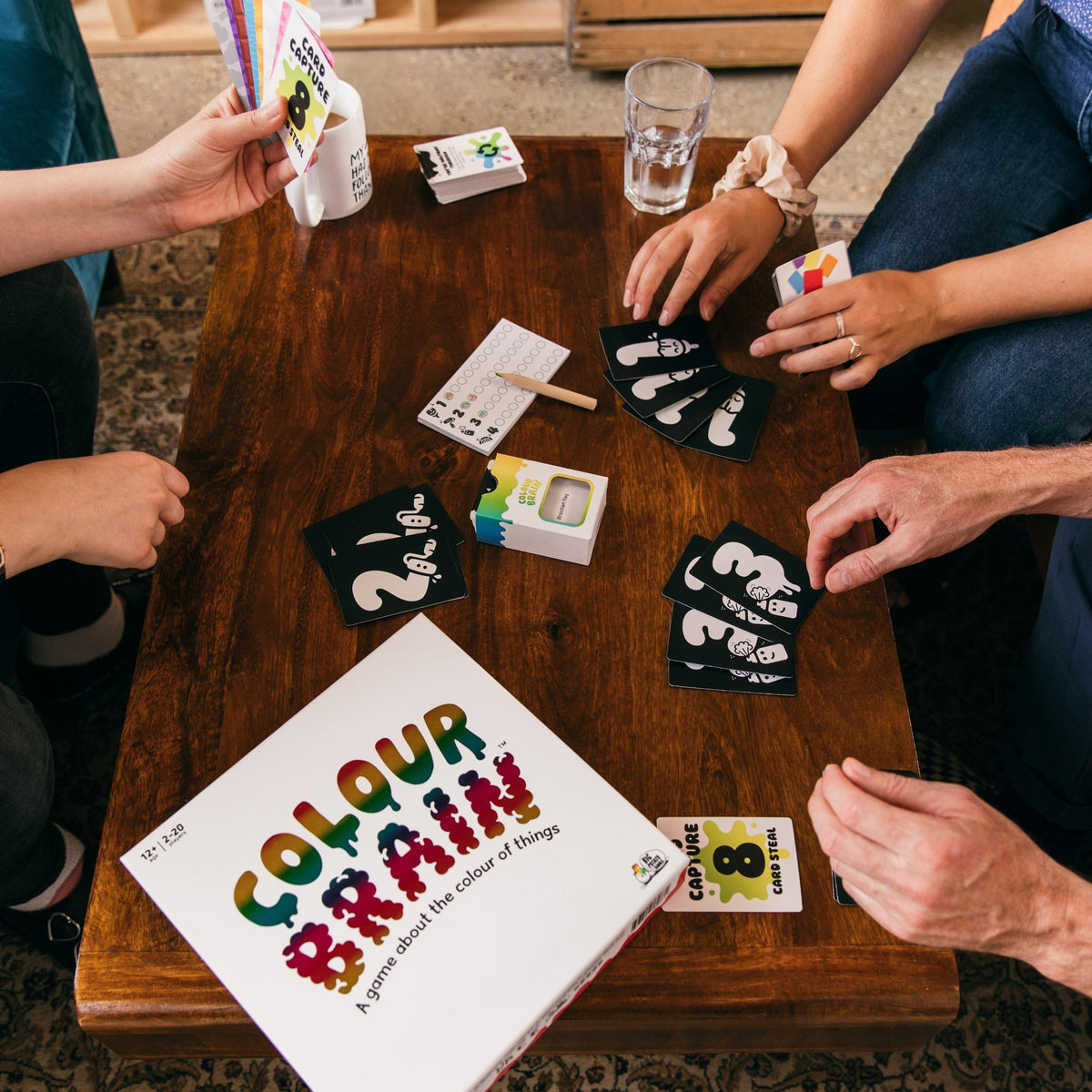 a table surrounded by players playing Colourbrain