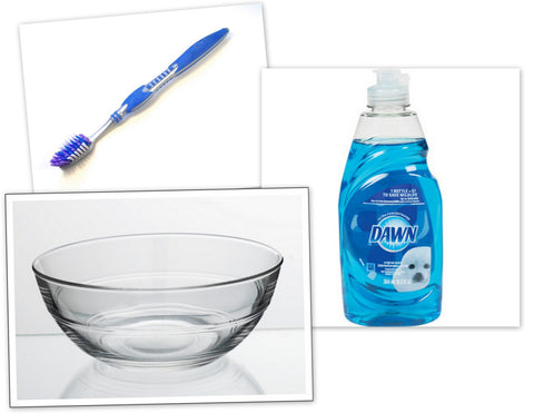 items needed to clean costume jewelry including water, mild dish soap and a soft brush