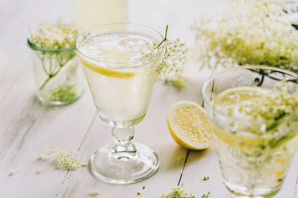 Elderflower Cordial in a glass with a slice of lemon