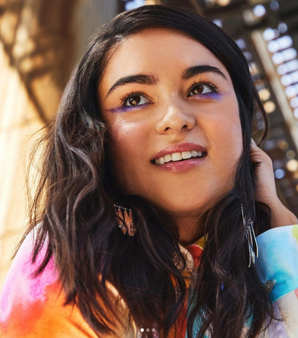 Image Devery Jacobs, smiling and looking away from the camera