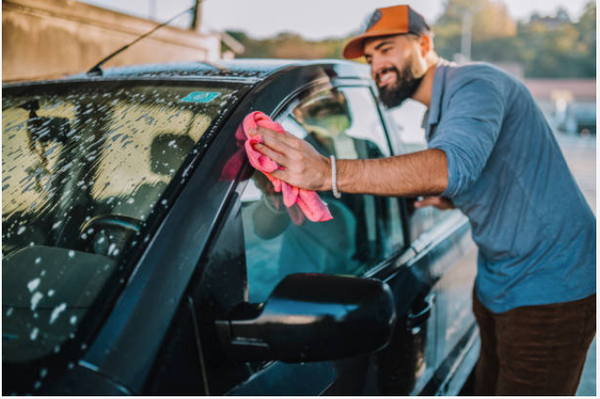 Man cleaning his car