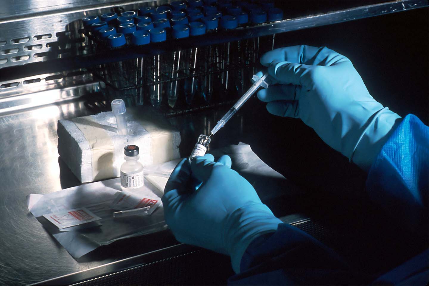 a scientist preparing medication in a sterile environment