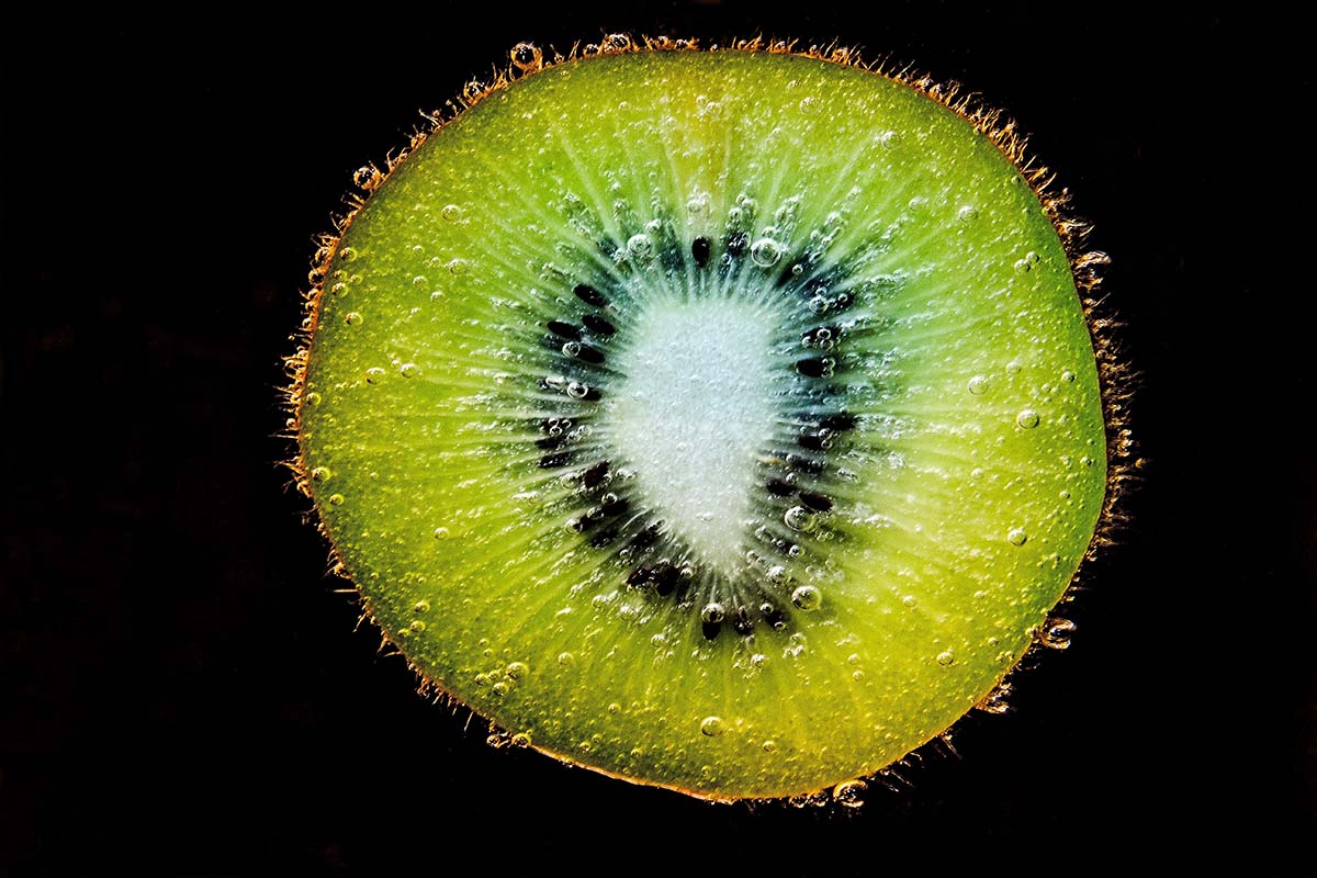 kiwi fruit sliced, displaying its vibrant green flesh and small black seeds