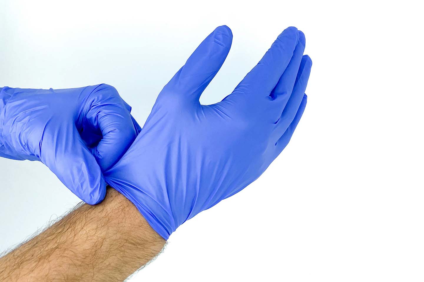 Hands putting on disposable gloves