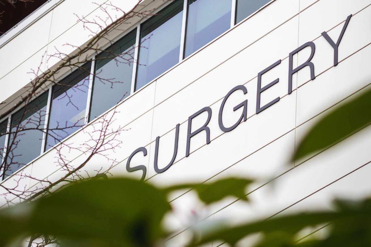 hospital building with sign saying surgery