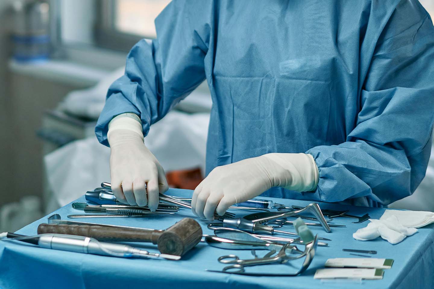 a medical professional arranging sterile surgical instruments for an operation