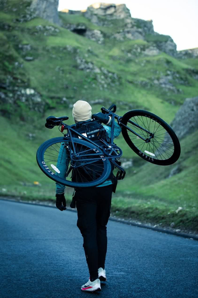 man carrying black Steed Bikes Stallion single speed in Peak District