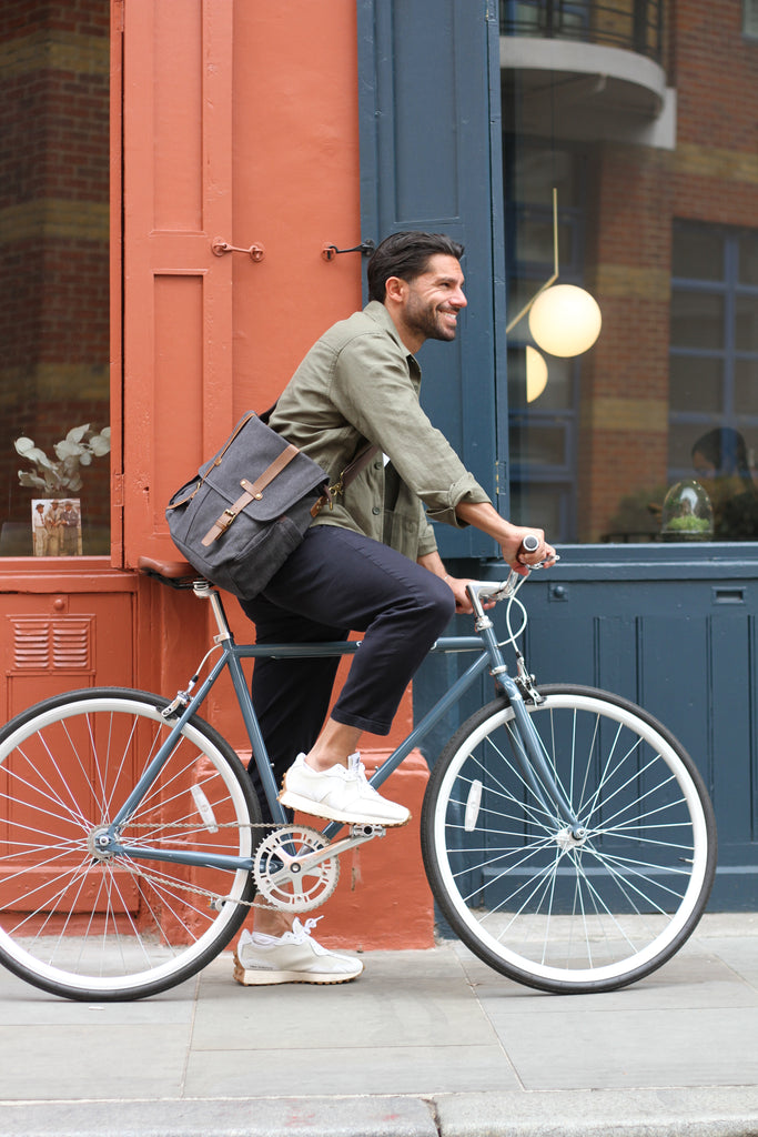 man in white trainers on Atlantic Blue Steed Bike Thoroughbred in front of orange and blue wall