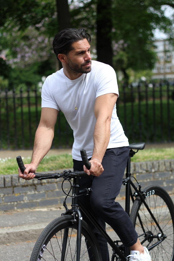 man in white muscle t-shirt on black fixie bike Steed Bike Stallion