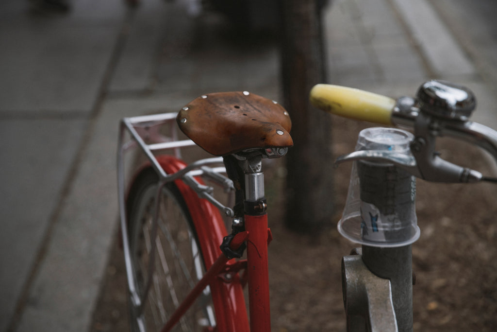 red bicycle with fenders mudguards and brown leather saddle