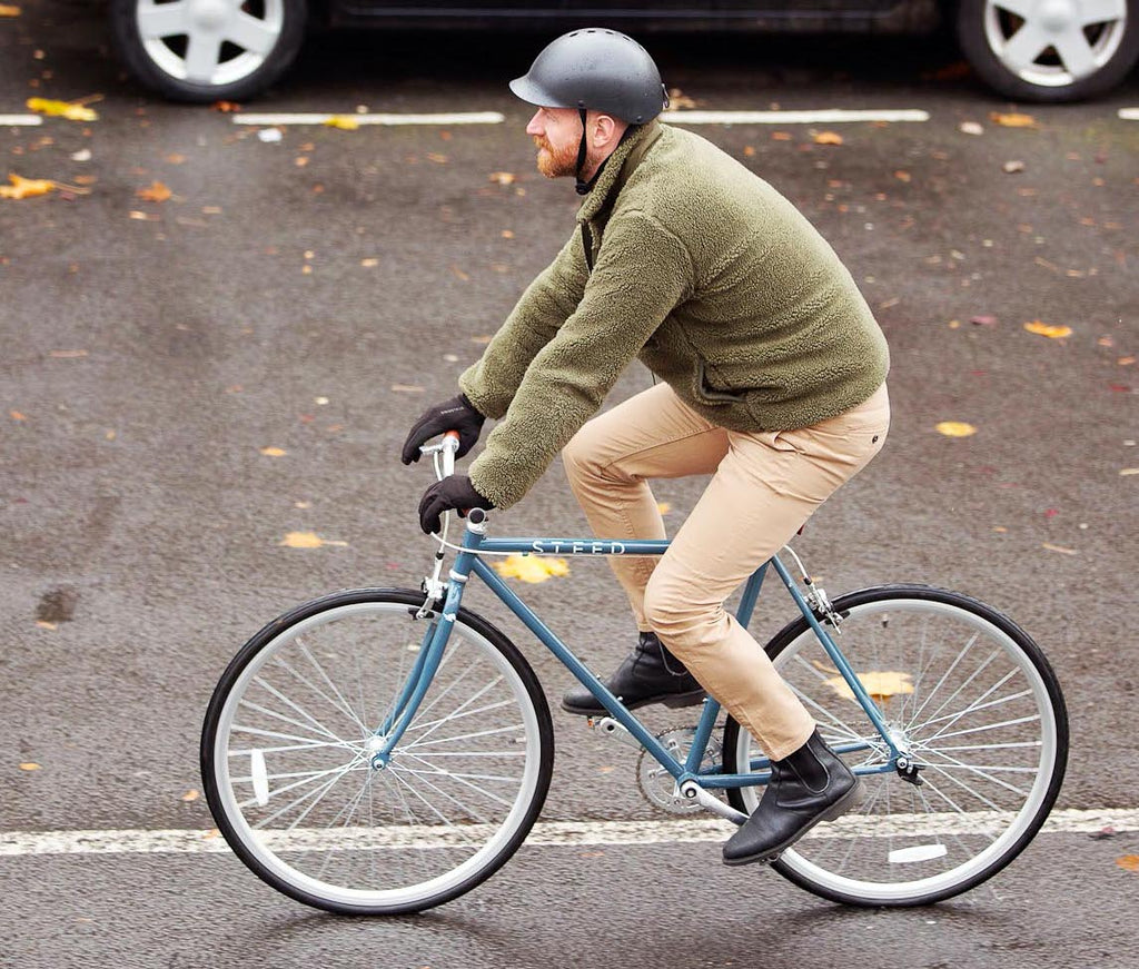 man on blue single speed bike cycling to work