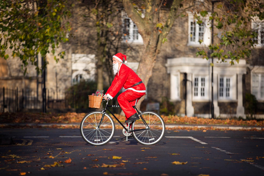 Santa on a black Steed Bike with front basket 