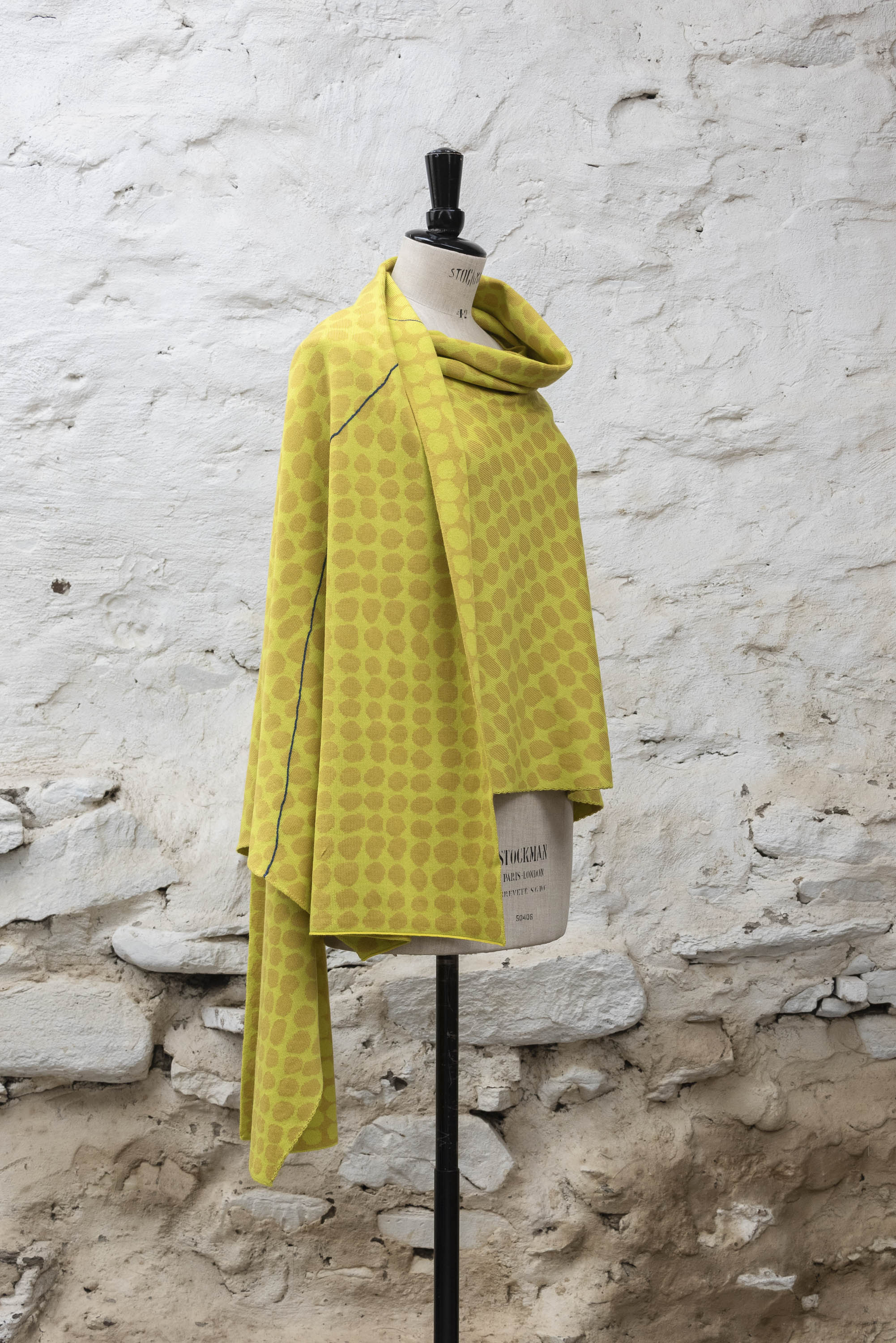 Contemporary Shetland shawl knitted in yellows with blue detail. Abstract pattern of irregular dots