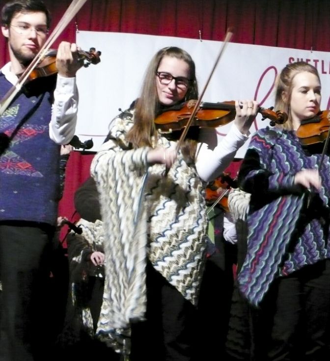 Hjaltibonhoga fiddlers perform at the opening ceremony of Shetland Wool Week, wearing Nielanell Shetland knitwear