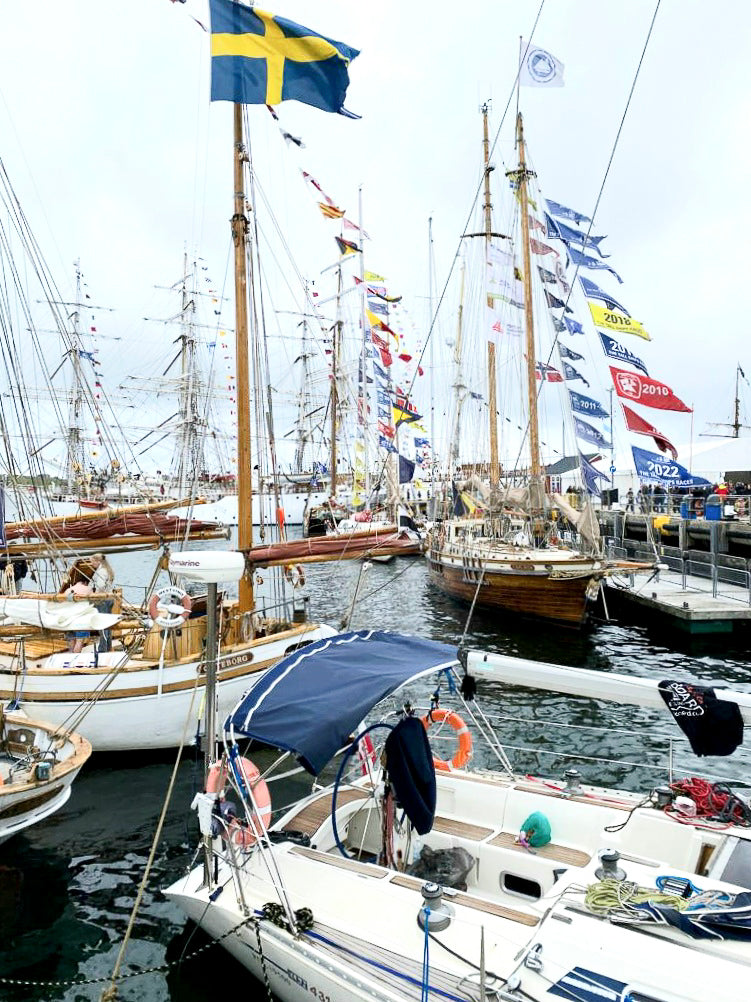 In the Harbout at Tall Ships Lerwick, many sailing boats moored with bunting and sails furled.
