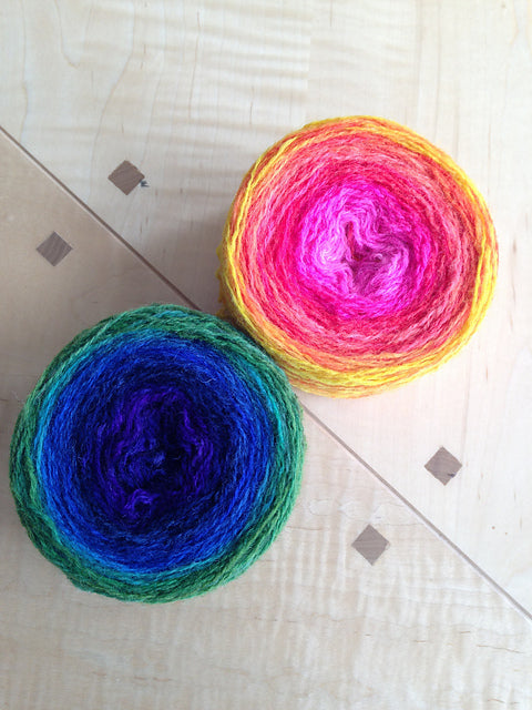 Two cakes of hand-dyed gradient Shetland yarn, unwound from sock blanks