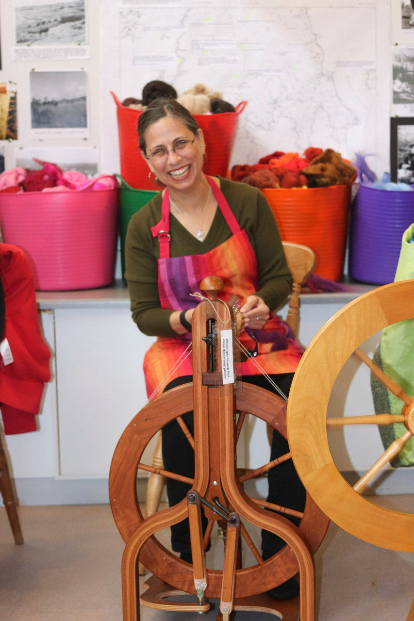 A woman handspins in Hoswick, Shetland, during Shetland Wool Week