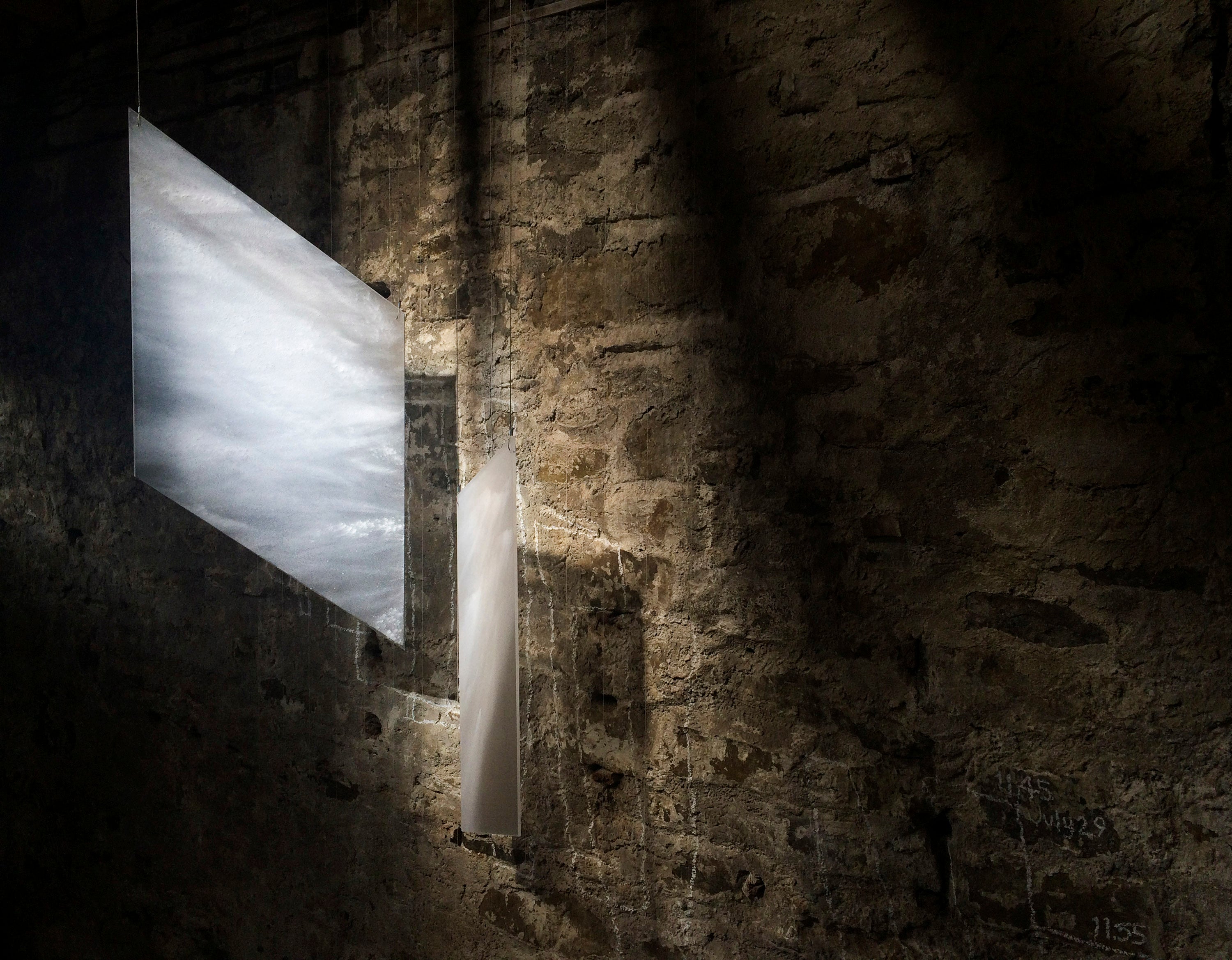 Installation in glass by Karlyn Sutherland. Glass panels made to echo shapes of light falling within the building. These exact shapes only occur once a year.