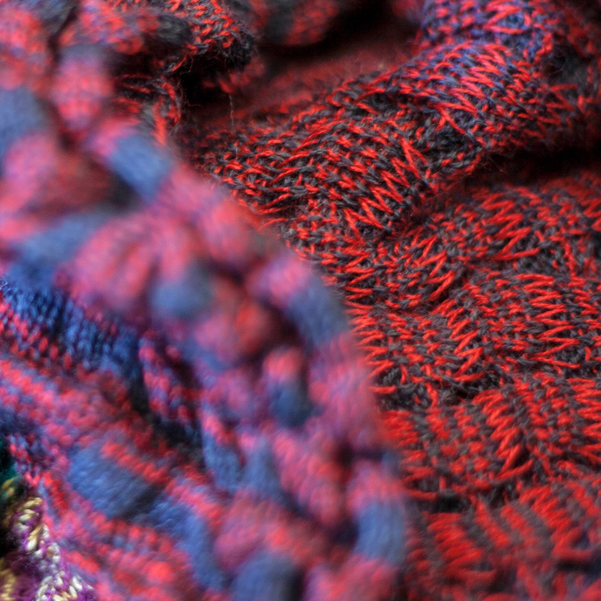 detail and back of rigg vaarie jacket. Red and blue stripes in a ridged, scrunchy textile