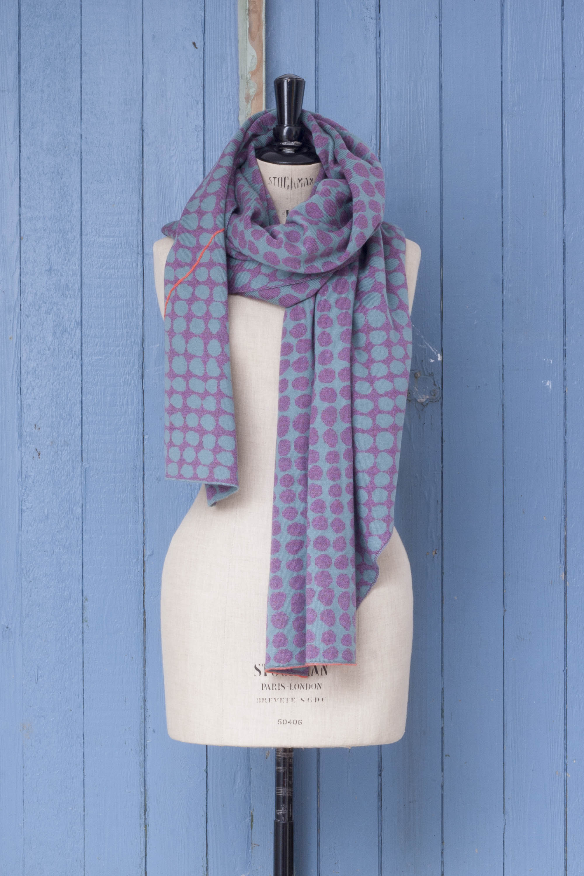 Ebb-stanes contemporary Shetland shawl made in Scotland. Pebble design in lilac and blue with hot pink individually drawn line