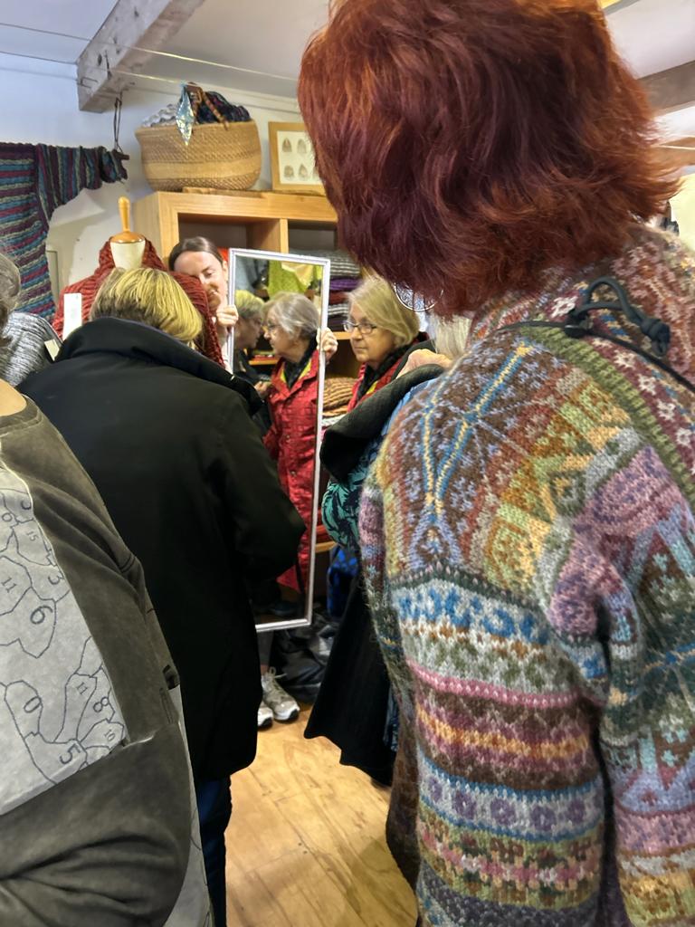 In the Nielanell knitwear studio, Shetland , a visitor wears an intricately patterned Fair Isle cardigan in many soft colours. Marie Wallin pattern