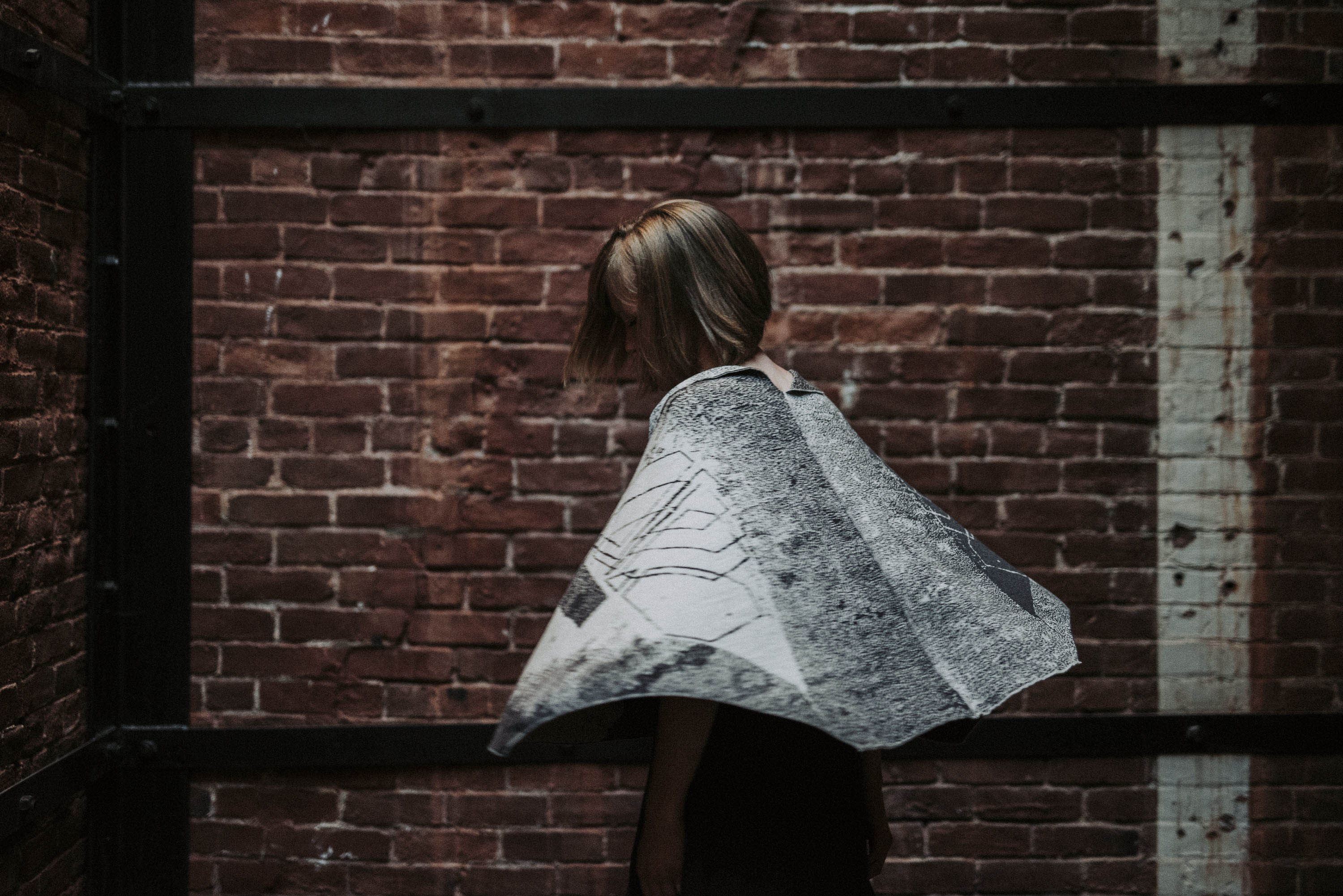 Model wearing byre cape spins, showing its shape