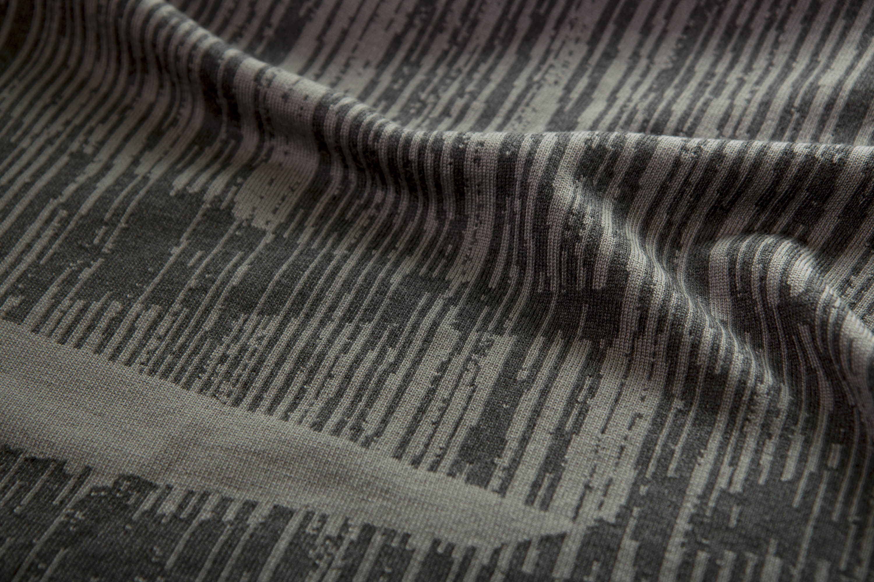 Detail of Inklines textile in dusk. Irregular lines overlap to create shapes, alongside negative space.