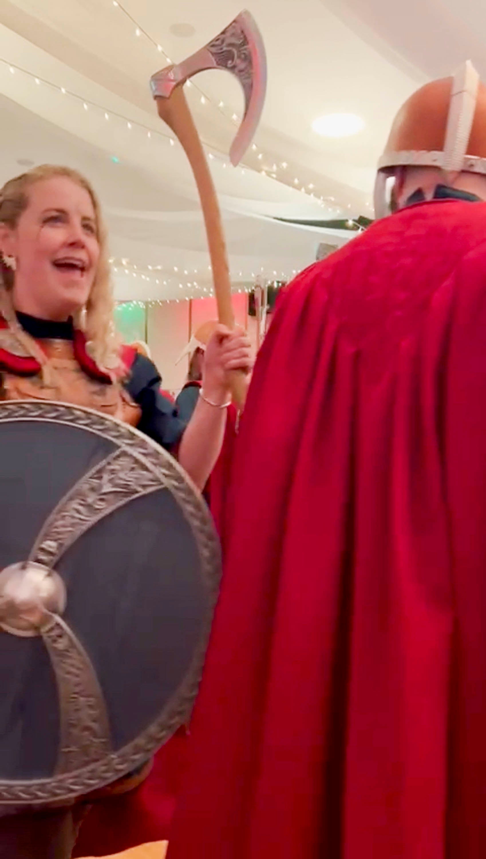 Viking guizers at Sandwick Hall during South Mainland Up Helly Aa. Male and femaile guizers process with axes.