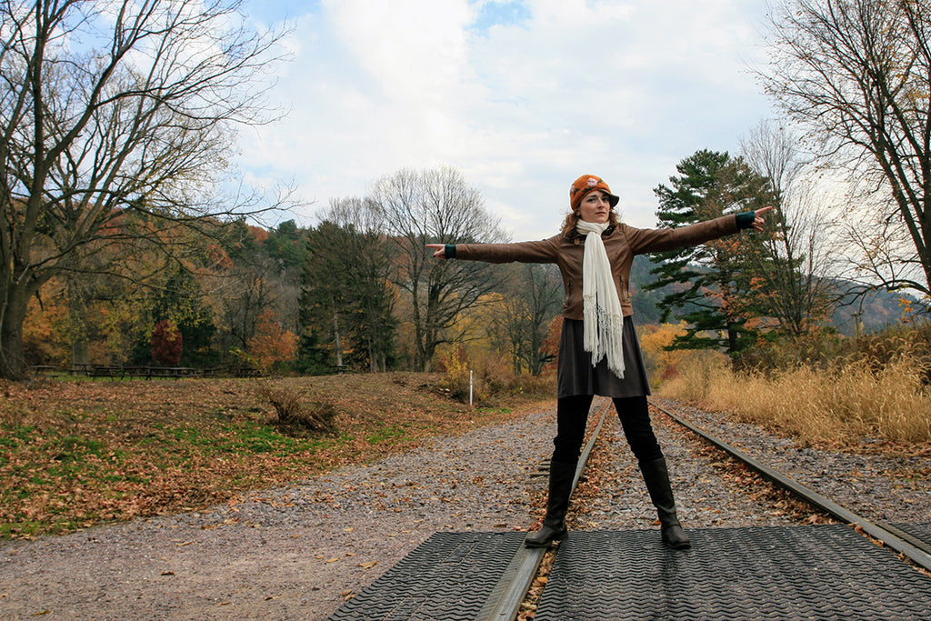 A 23 year old Adrianne outside in the fall on some railroad tracks