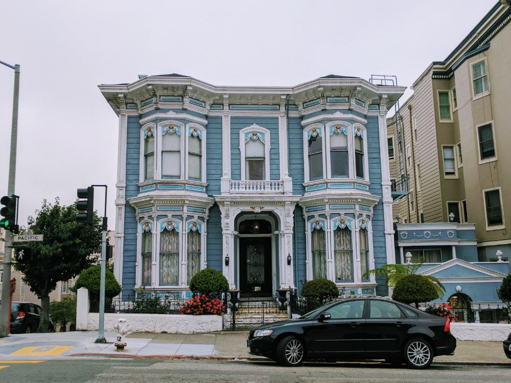 Straight on view of a blue SF Victorian home