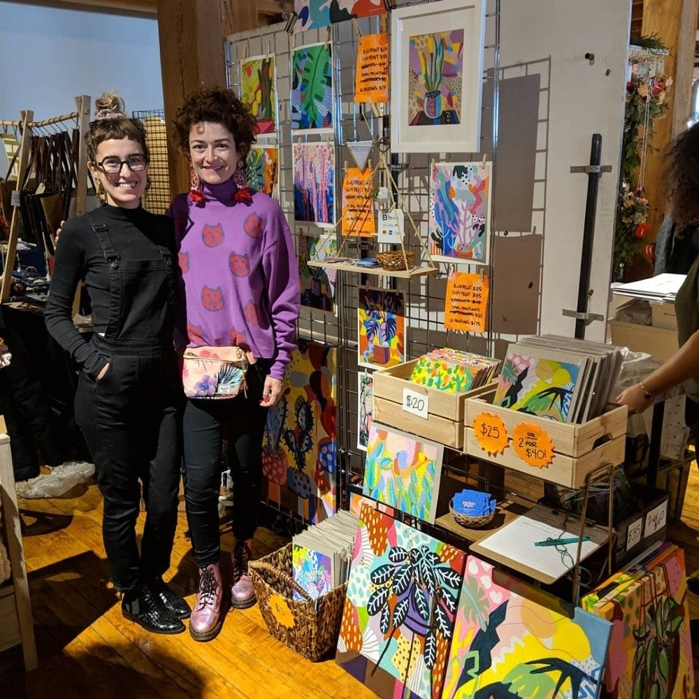 The artist and her sister in a craft show booth