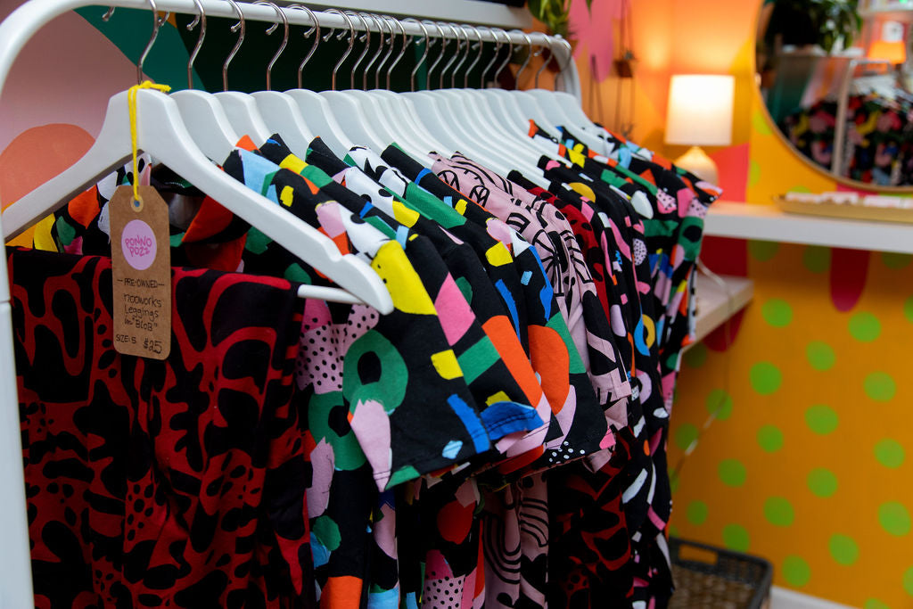 A clothing rack featuring brightly colored tops in the first Ponnopozz store.