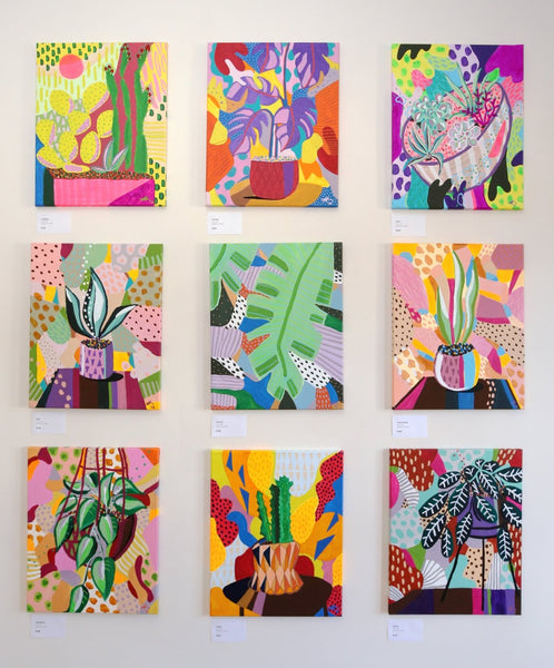 9 paintings on a wall of different plants