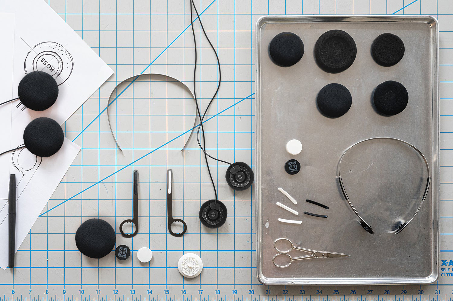 Dissected view of Koss KPH40 Utility Headphone parts laid out on a table.