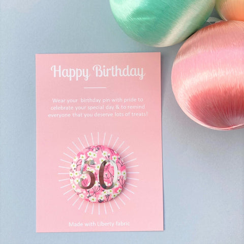 50th Birthday badge in pink floral fabric on a pink Happy Birthday postcard