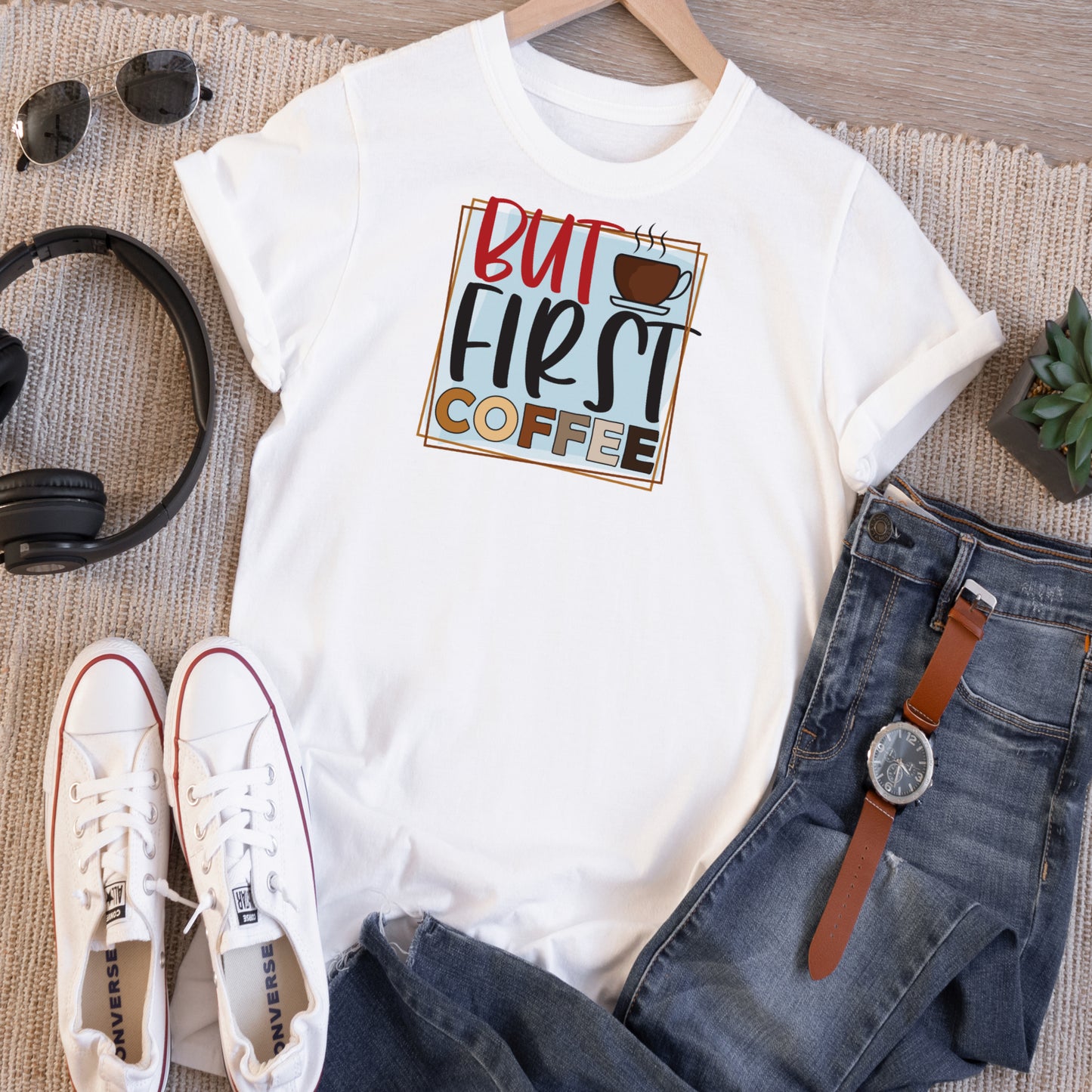 White short sleeve Tshirt with a vinage graphic that says But First Coffee in colors of red, black,brown,with a blue background.