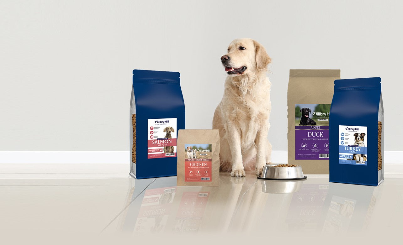 Millbry Hill range of dog food surrounding a Golden Retriever