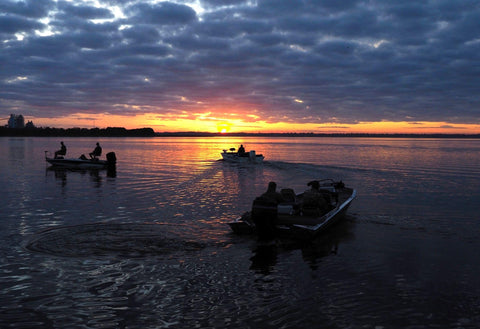 Fishermen head out in their boats at sunrise to go fishing