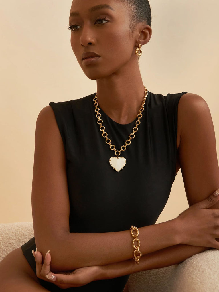 Woman wearing a gold heart pendant necklace