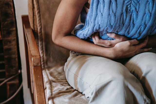 A person holding their stomach in pain